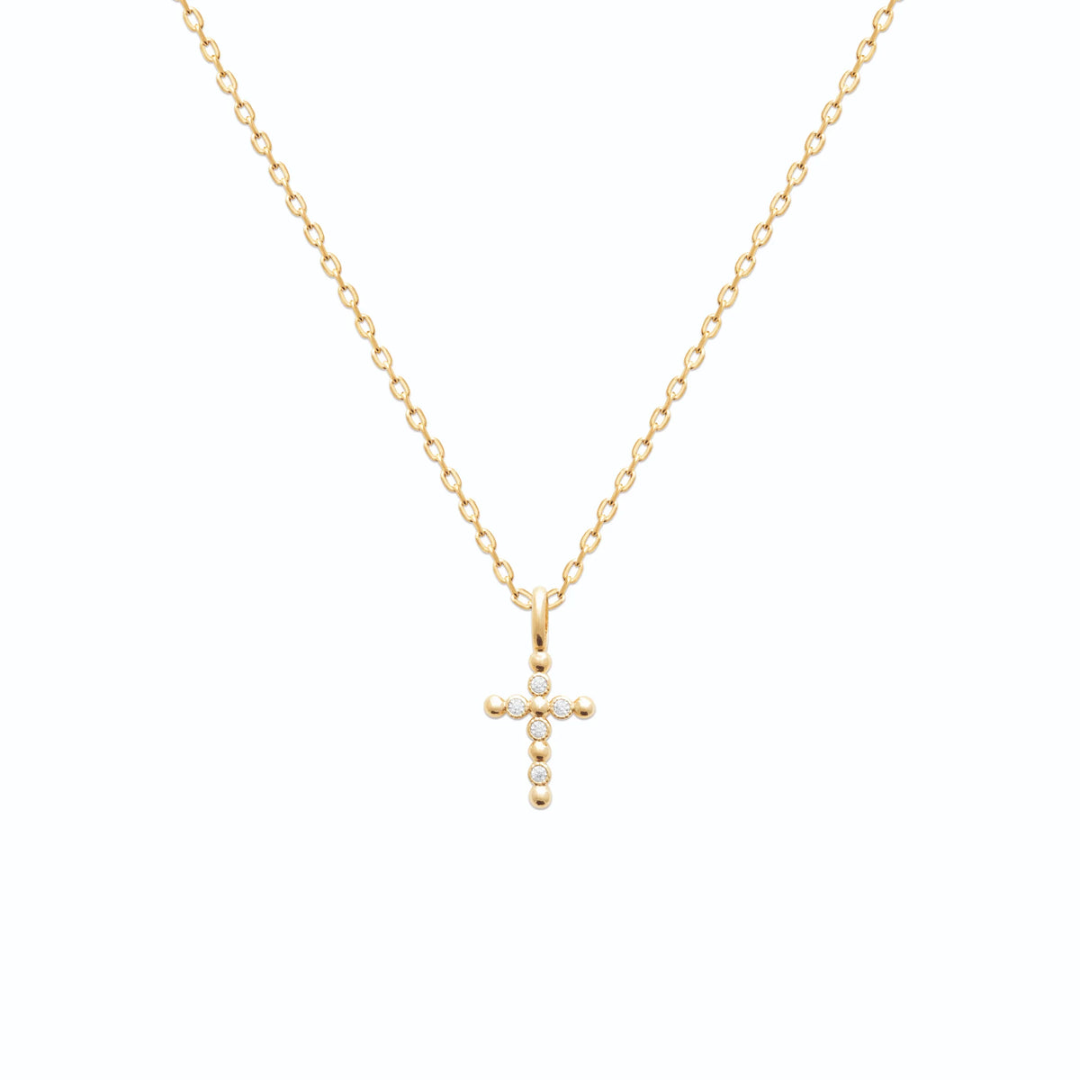 Pendentif croix à boules serties de zircons en plaqué or vu de profil