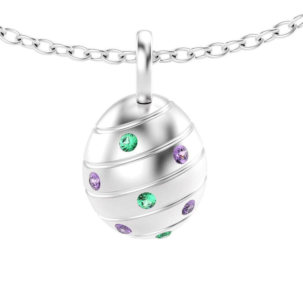 pendentif oeuf pour femme en or blanc avec saphirs violets et  emeraude