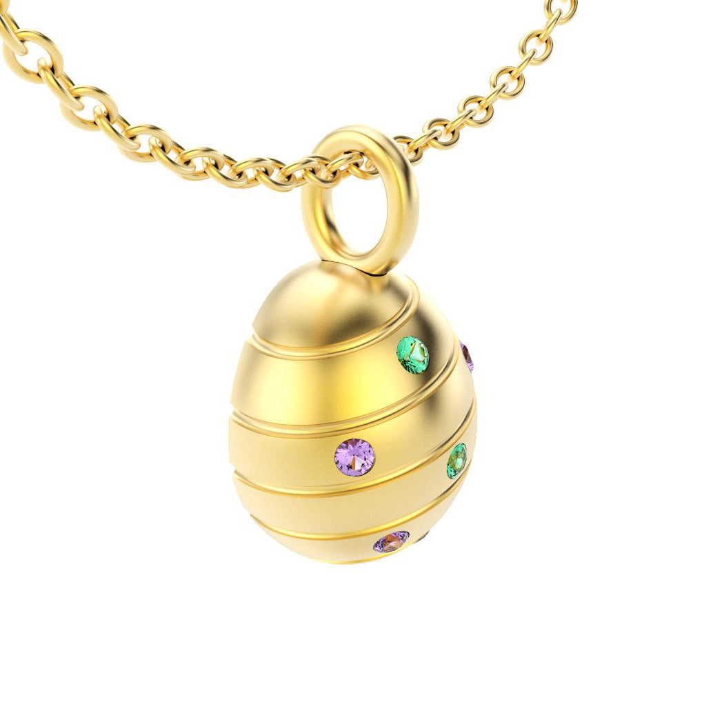pendentif oeuf pour femme en or jaune avec emeraude et saphirs violets