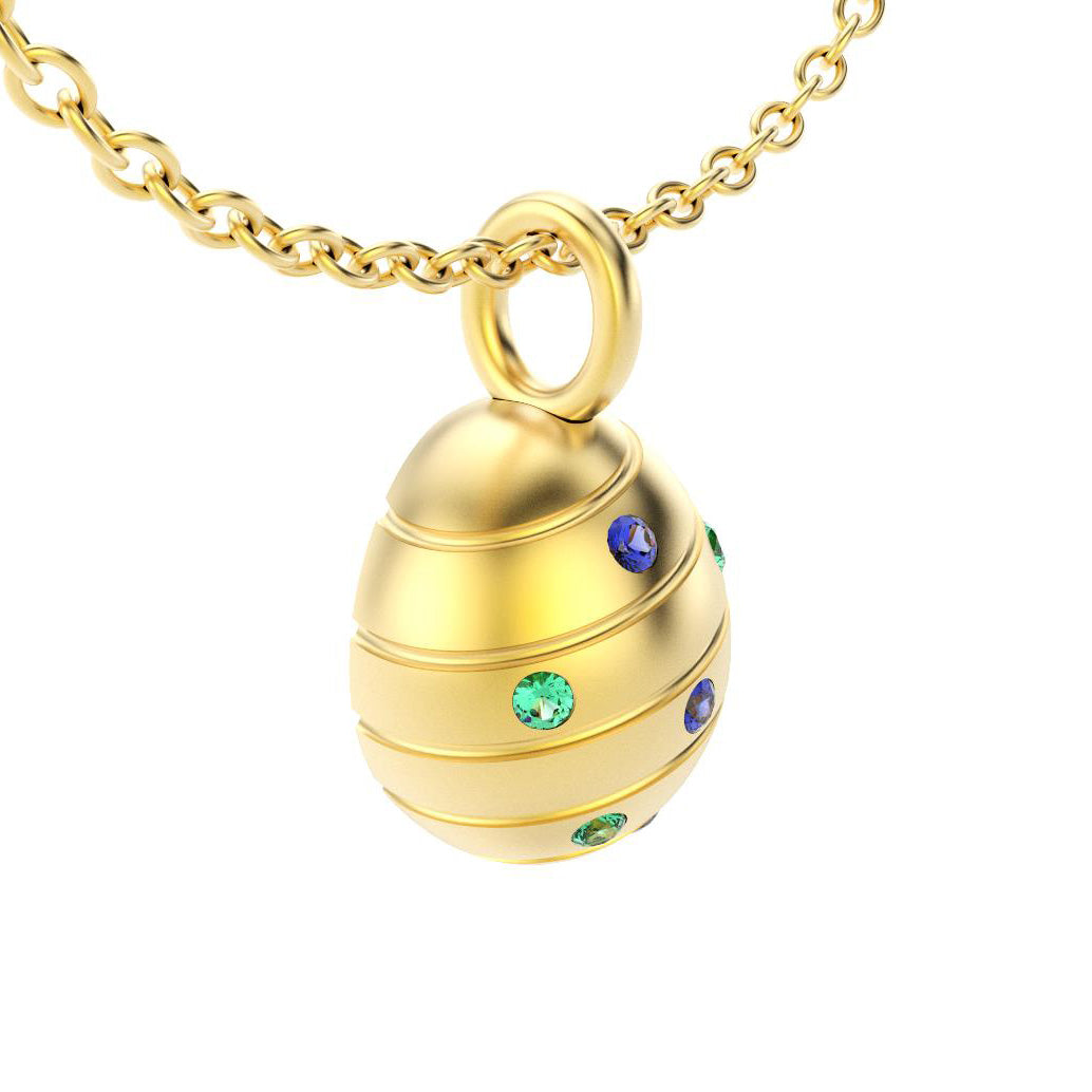 pendentif oeuf pour femme en or jaune avec saphirs bleus et emeraudes bleus