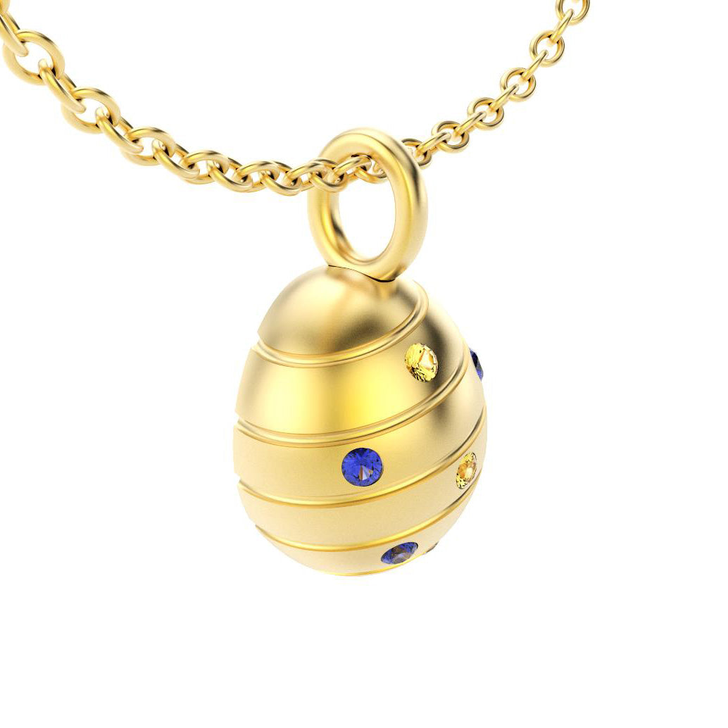 pendentif oeuf pour femme en or jaune avec saphirs bleus et saphirs jaune
