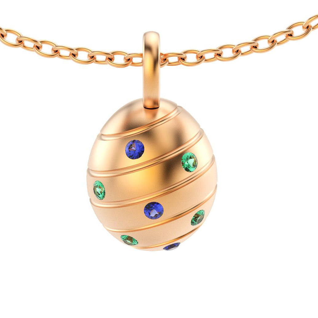 pendentif oeuf pour femme en or rose avec saphirs bleus et emeraudes