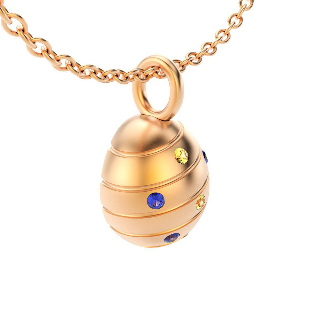 pendentif oeuf pour femme en or rose avec saphirs bleus et saphirs jaune