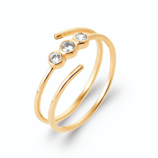 Bague double anneau spirale ouverte et trois zircons alignés en plaqué or, vue de trois quarts