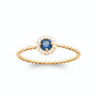 Bague pierre bleu nuit entourée de zircons et anneau perlé en plaqué or