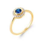 Bague ronde bleu outremer serti clos entourage de zircons en plaqué or