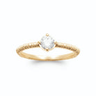 Bague solitaire zircon rond quatre griffes sur anneau strié en plaqué or