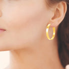 Boucles d’oreilles créoles plates 38 mm en acier PVD doré