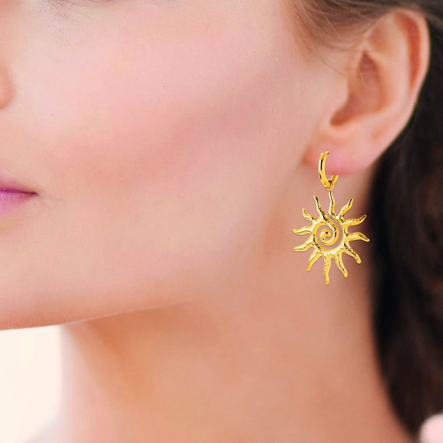 Boucles d’oreilles créoles et soleil spirale en acier PVD doré, portées à l’oreille