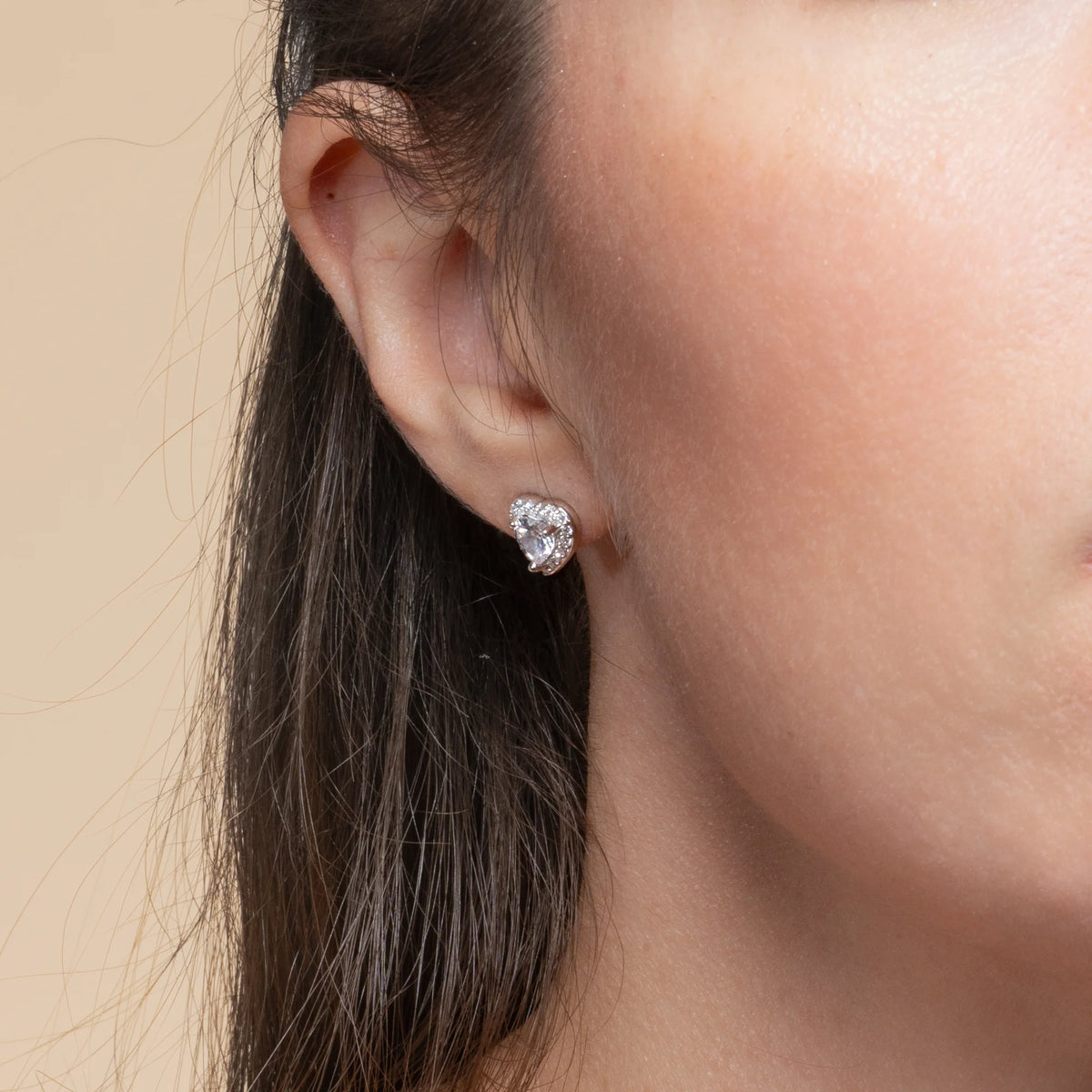 Boucles d’oreilles puces cœur et halo de zircons en argent 925, portées par une femme