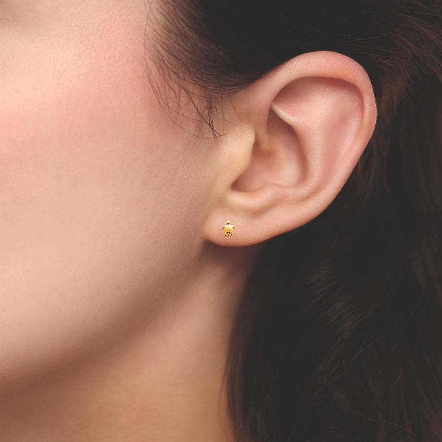 Boucles d’oreilles puces tortue ciselée enfant en plaqué or, portées à l’oreille