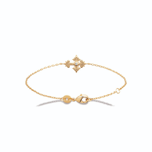 Bracelet chaîne fine croix à volutes et zircon en plaqué or