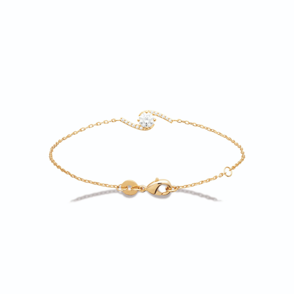 Bracelet chaîne fine vague de zircons autour d’une pierre ronde en plaqué or
