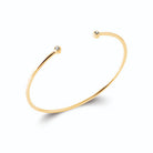 Bracelet jonc ouvert fin à extrémités perlées en plaqué or