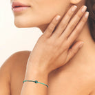 Bracelet perles bleu-vert et pierre centrale en acier PVD doré