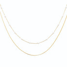 Collier double rang ponctué de perles d’imitation en acier doré