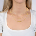 Collier triple rang chaîne serpent et grain de riz en acier doré