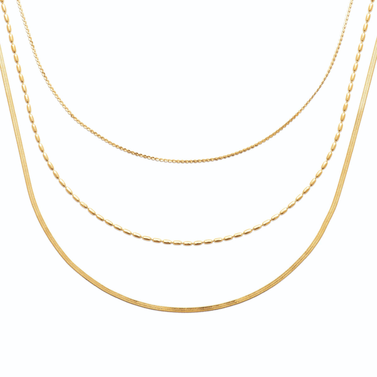 Collier triple rang chaîne serpent et grain de riz en acier doré