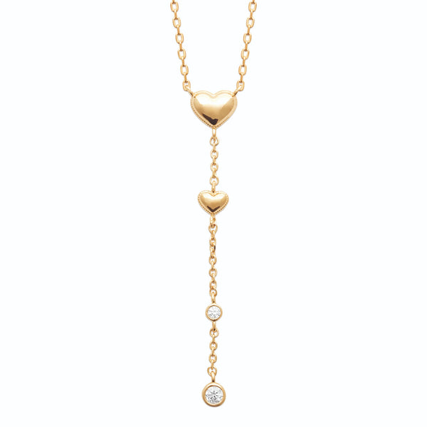 Collier en Y en plaqué or, cœur bombé lisse, second cœur plus petit et deux zircons sertis clos en chute