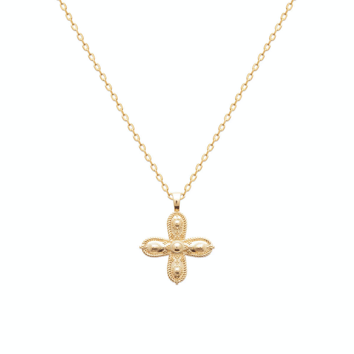 Pendentif croix pattée ornementée en plaqué or vu de profil