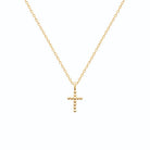 Pendentif croix perlée en plaqué or vu de profil